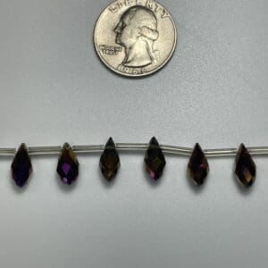 Purple and brown teardrop beads size comparison.