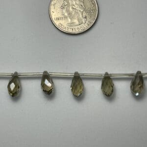 Five smoky quartz teardrop beads.