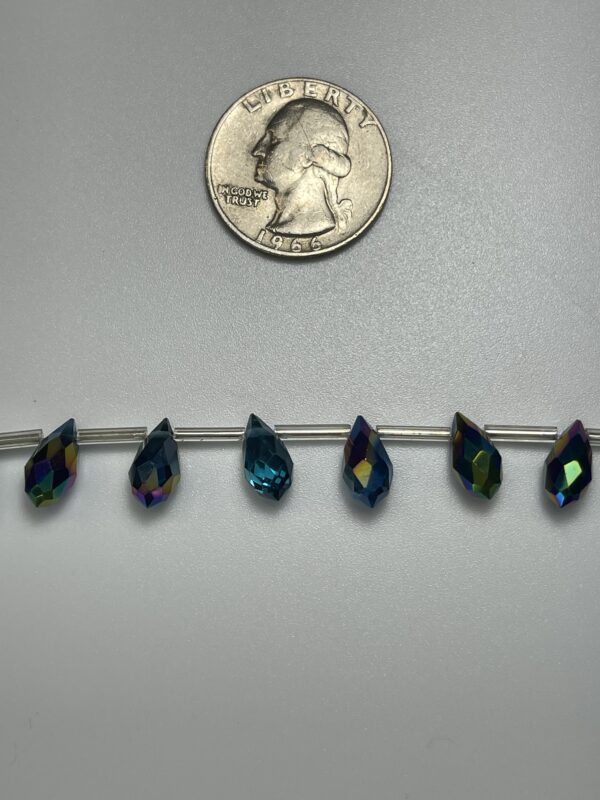 Teal iridescent teardrop beads on wire.