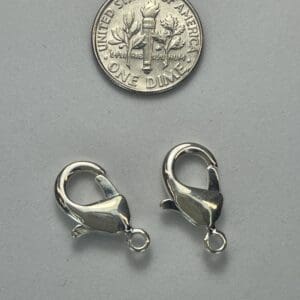 Two silver clasps with a US dime.