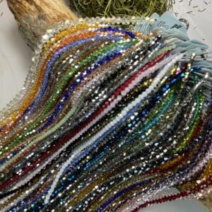 Colorful beaded necklaces on wooden display.