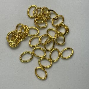 Gold oval metal rings on surface.