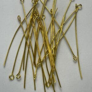 Gold eye pins on a white background.
