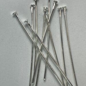 Silver headpins on a white background.