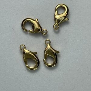 Four gold lobster claw clasps.