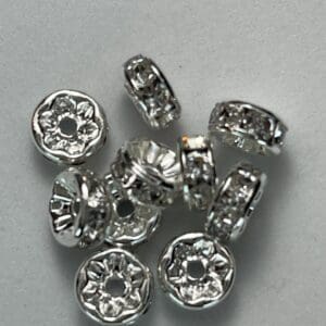 Silver spacer beads on a white background.