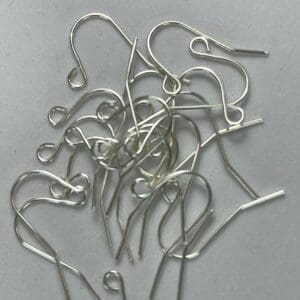Silver earring hooks on a white background.