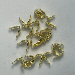 Gold lobster claw clasps on surface.