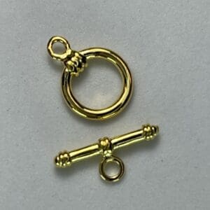 Gold toggle clasp on a plain background.