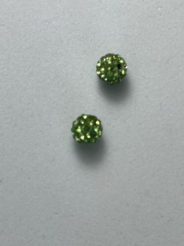 Two small green sparkly beads.