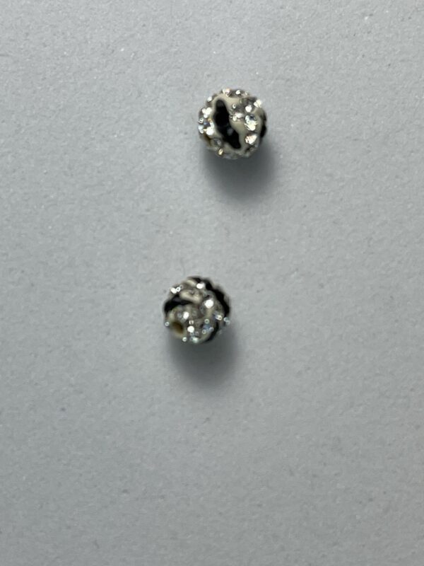 Two sparkly black and white beads.