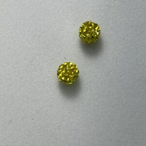 Two small, round, yellow textured beads.