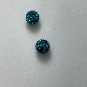 Two small blue glittery buttons.