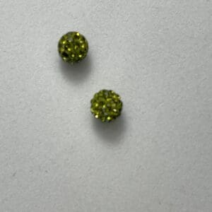 Two small green textured round objects.