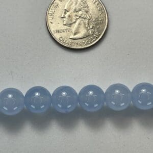 Light blue chalcedony beads with quarter.