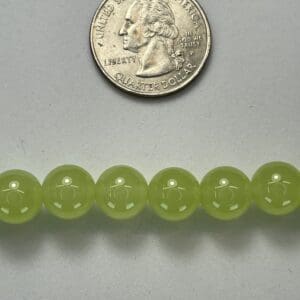 Light green beads with quarter for scale.
