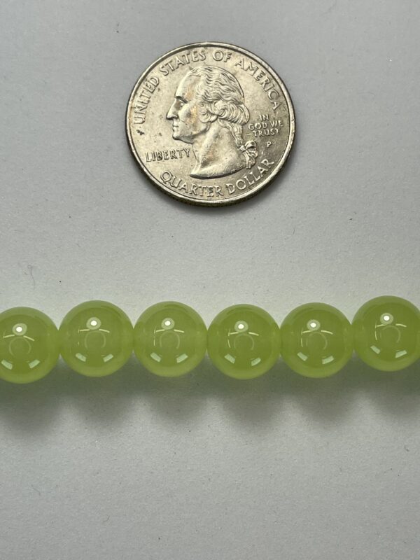 Light green beads with quarter for scale.