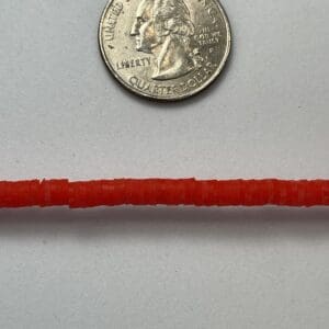 Red string with a U.S. quarter coin.