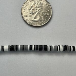 Quarter and black-and-white beaded bracelet.