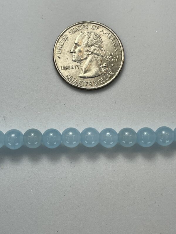 Light blue beads with quarter for scale.