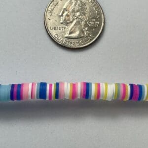 Colorful beads and a U.S. quarter.