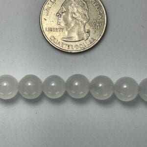 Quarter next to frosted glass beads.