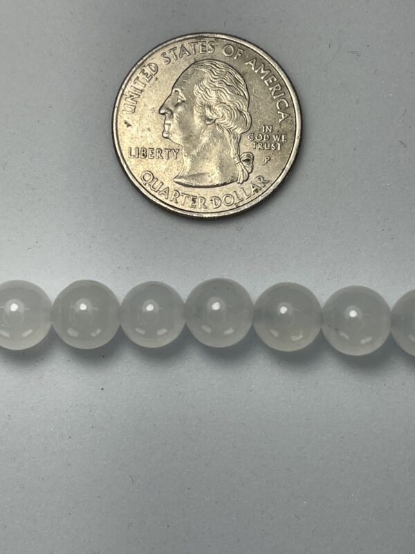 Quarter next to frosted glass beads.