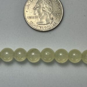 Pale green beads with quarter for scale.