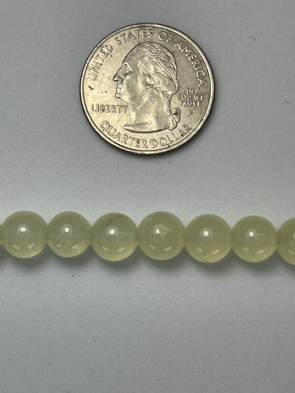 Pale green beads with quarter for scale.