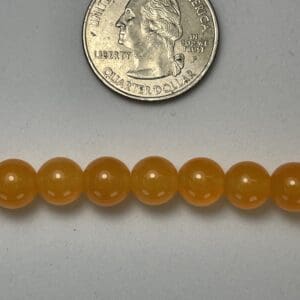 Orange beads with US quarter for scale.