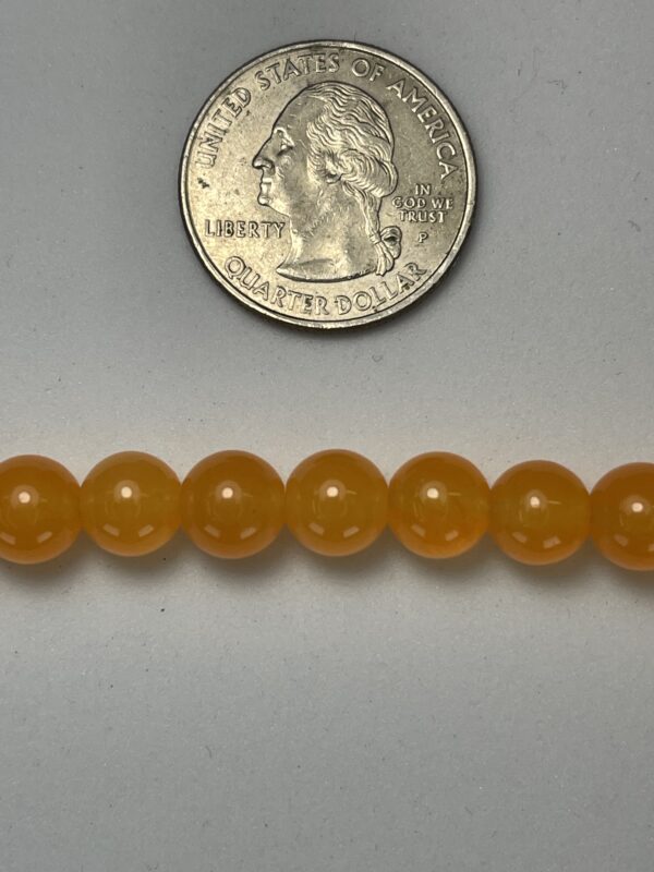 Orange beads with US quarter for scale.
