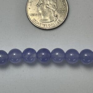 Lavender beads with quarter for scale.