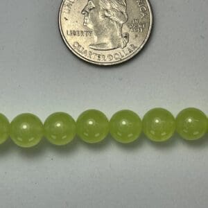 Lime green beads with quarter for scale.
