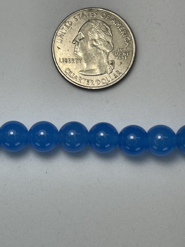 Blue beads with quarter for scale.